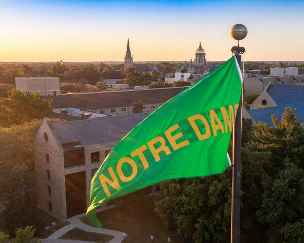 Green and gold Notre Dame pennant flies above the stadium