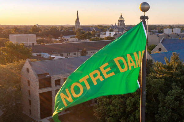 Green and gold Notre Dame pennant flies above the stadium